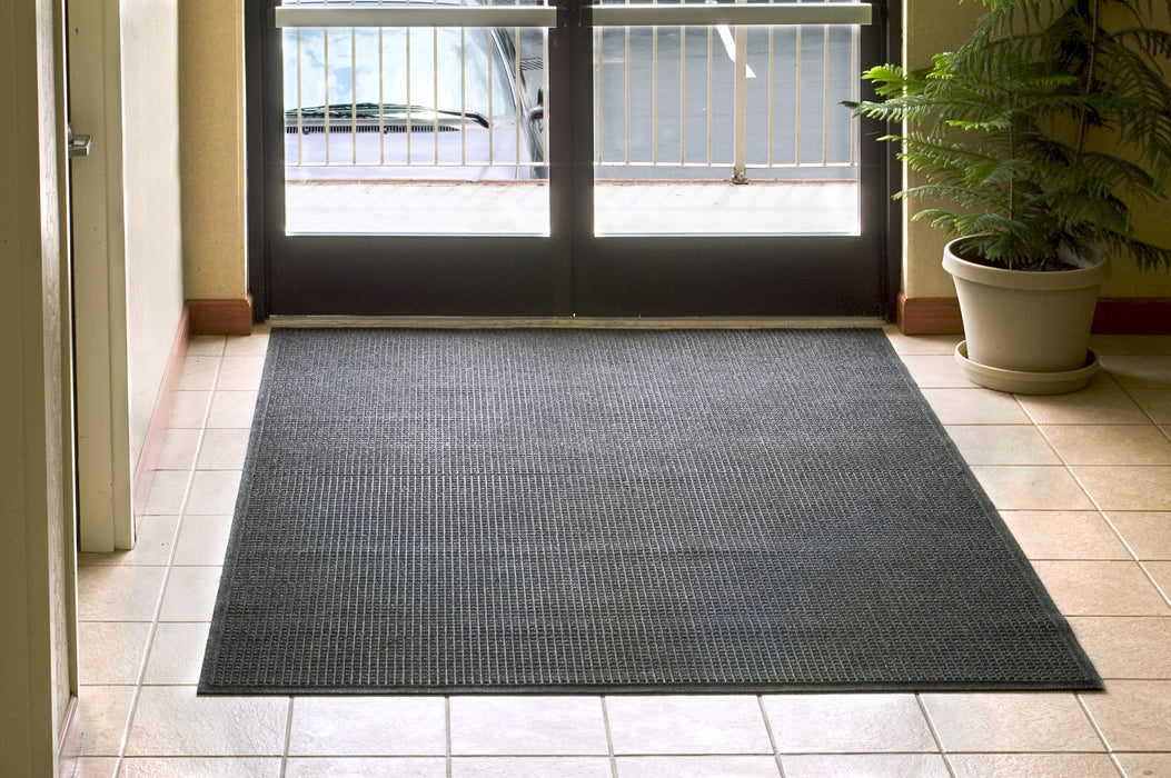 Insitu image of a charcoal Waterhog Fashion Mat in an office entranceway perfect for foot traffic. The Mat Group UK.