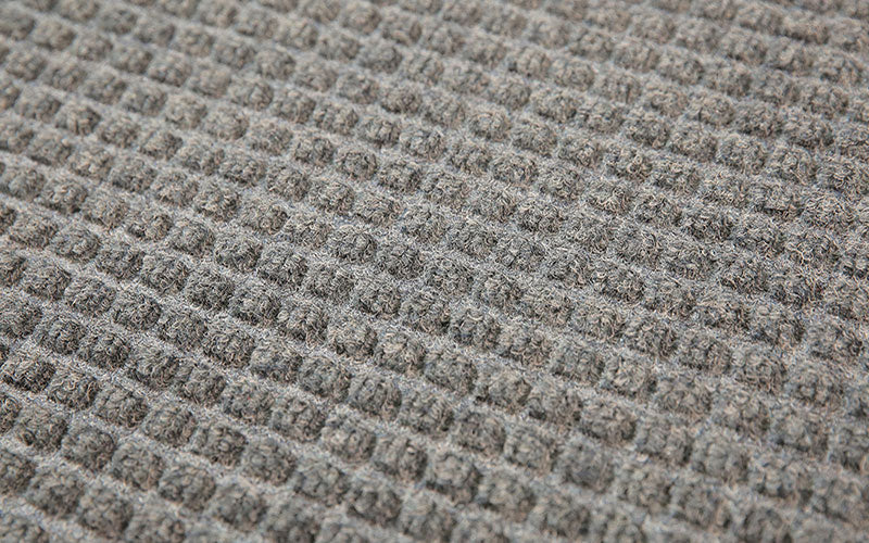 Close up image of the "waffle" like texture of the Waterhog fashion mat in medium grey. The Mat Group UK.