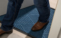 Insitu image of a Medium Blue Waterhog Premier Mat used in an office building. The Mat Group UK.