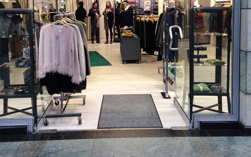 Insitu image of the Black Mink Entry Plush Mat in a retail store entrance.