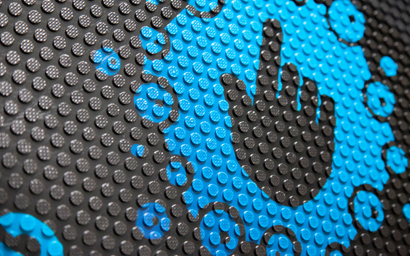 Close up of the raise rubber surface with a logo printed on top.